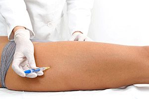 Woman having leg botox treatment at beauty clinic